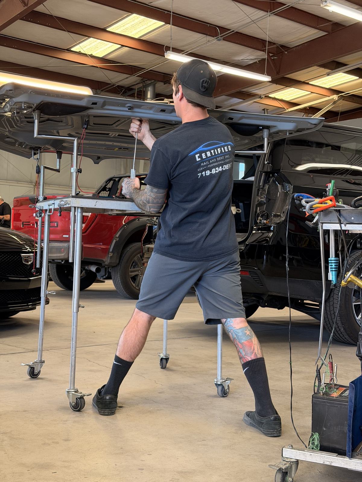 Certified Hail and Dent technician repairing vehicle panel in Colorado Springs