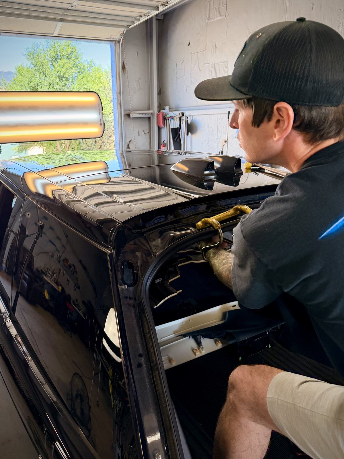 Technician repairing hail damage on vehicle roof Colorado Springs